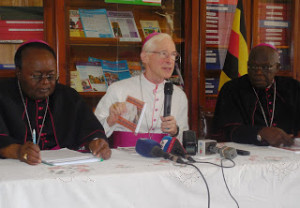 H.E. Most Rev. Michael August Blume, the Apostolic Nunci to Uganda (center) shows to the press a copy of a booklet of the Amoris Laetitia. He is flanked by the Chairman of the Uganda Episcopal Conference and Archbishop of Gulu, Most Rev. John Baptist Odama (right) and the Archbishop of Kampala, Most Rev. Cyprian Kizito Lwanga (left)